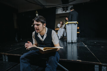 Group of young actors engaging in a dramatic theatrical performance, showcasing emotional...