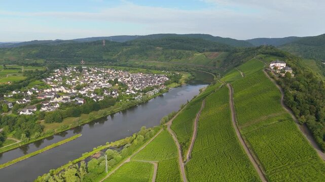 Marienburg castle on Petersberg, aerial panorama view over Moselle valley, vineyards, mountain range of Eifel and Hunsrueck, Mosel river loop near Zell, Germany