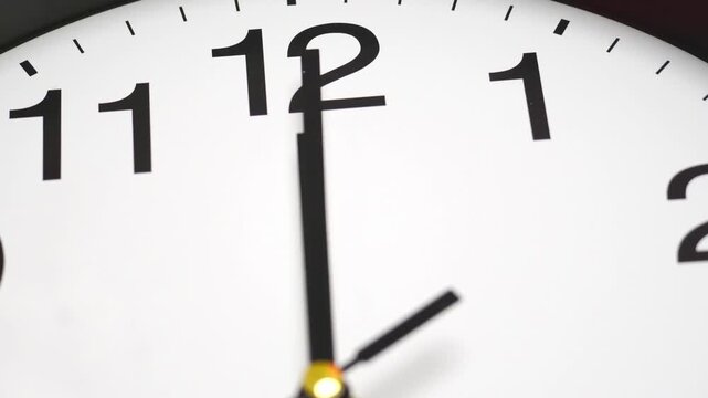 4K footage Time lapse Move Camera close-up white analog clock displaying the time 11:55 with sharp black hands and numerals, Themes of urgency countdown and time management.