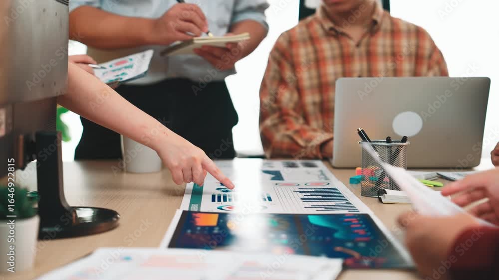 Poster a diverse business team actively discussing strategies while analyzing colorful charts and graphs in