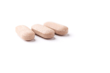 Ashwagandha (Withania somnifera) tablets on paper background. Soft focus. Close up. Copy space.	