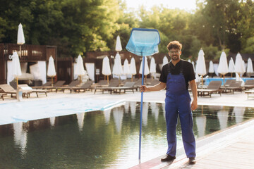 Pool cleaner holding cleaning net by the poolside