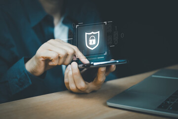 Close-up of hands holding a smartphone, with a glowing security shield and padlock icon overlaid. Data privacy, and online protection against cyber threats. Digital security concept.