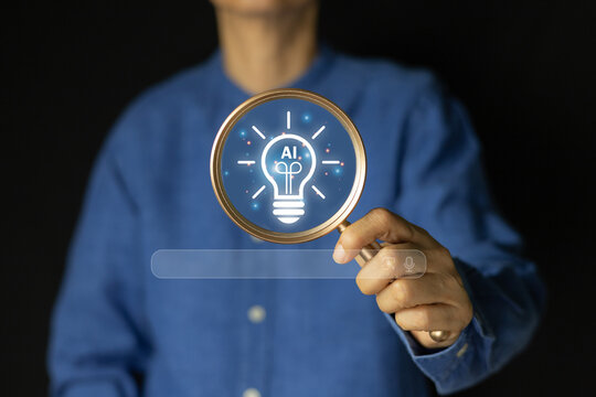 A person holding a magnifying glass over a glowing light bulb with the "AI" icon inside, representing the concept of artificial intelligence, innovative ideas, and discovering new solutions.
