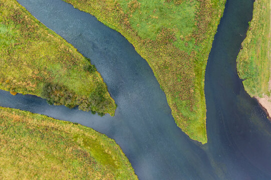 Aerial view of river meandering in green landscape Iceland