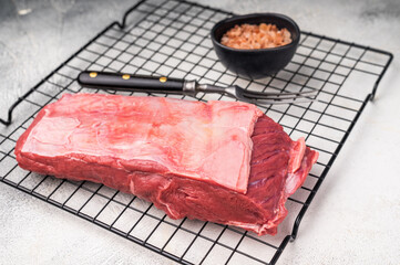 Close-up of raw buffalo meat cuts, highlighting the marbling and vibrant hue, perfect for creating delicious and nutritious dishes. grey background. top view