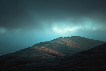 A moody mountain peak bathed in a cool, ethereal light, shrouded in mist and soft shadows