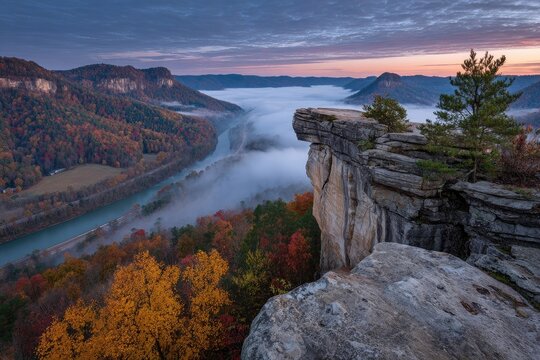 Autumnal vista of a rocky outcrop overlooking a misty river valley - Powered by Adobe