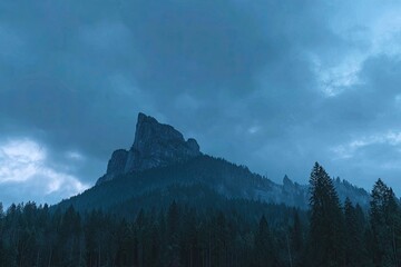 Misty mountain peak silhouettes against a twilight sky