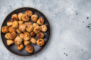 Savory meatballs, meat dumplings garnished with fresh herbs. A delightful addition to any meal, bringing warmth and satisfaction to the table. grey background. top view