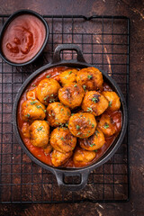 Juicy meatballs, perfectly seasoned and beautifully browned, ready to be served with marinara sauce. A classic comfort food that never disappoints. brown background. top view