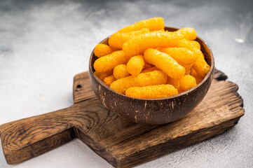Irresistible Cheese puffs, cheese snacks bursting with bold flavors and a satisfying crunch. grey...