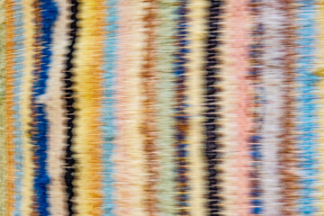 Abstract streaks overlap and blend together, creating a vibrant, swirling pattern. The overall...