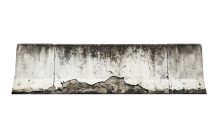 A weathered concrete barrier shows signs of aging and cracks, reflecting time and exposure in a bright outdoor setting