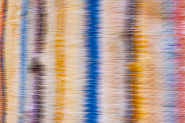 Abstract streaks overlap and blend together, creating a vibrant, swirling pattern. The overall...