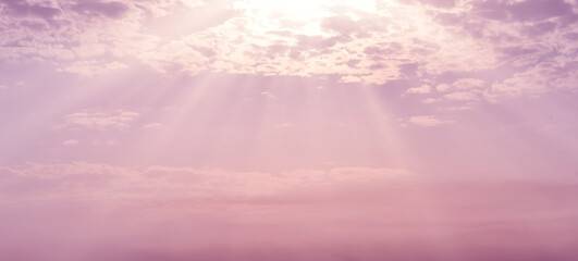 Purple pink golden sky with cloud. Sunlight shining through the clouds. Beautiful sunrise in the morning.