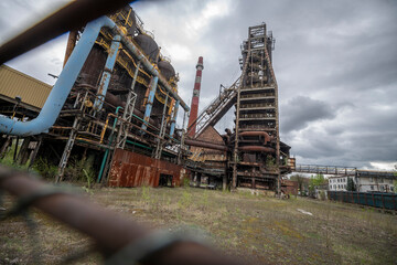 Fototapeta premium Abandoned Heavy Industrial Ruins with Large Blast Furnace in Steelworks