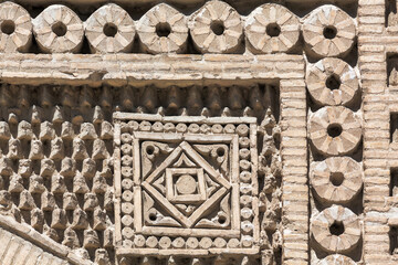 Detailed geometric brick ornament on Samanid Mausoleum facade in Bukhara, Uzbekistan