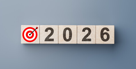 New year 2026 business concept with target board icon and number on wooden blocks against grey background for planning ahead