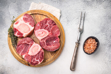Beautifully marbled raw veal ossobuco, perfect cross cut shank meat for traditional Italian recipes and savory family dinners. white background. top view