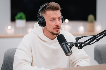Engaging conversation during a podcast recording in a modern studio setting with a man wearing headphones