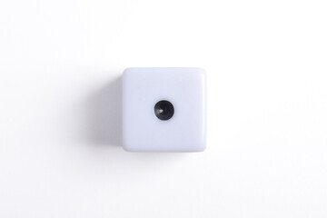 One white dice isolated on white background, top view
