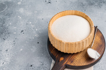 Versatile white sugar in a rustic bowl, ready to enhance desserts and beverages with its delightful...