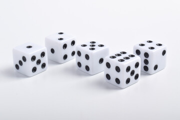 Five white dice on white background, symbolizing luck, chance, probability, and gaming concepts for...