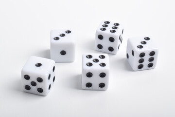 Five white dice on white background, symbolizing luck, chance, probability, and gaming concepts for board games