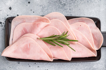 Gourmet sliced ham on a rustic board, inviting you to explore delicious recipes and delightful...