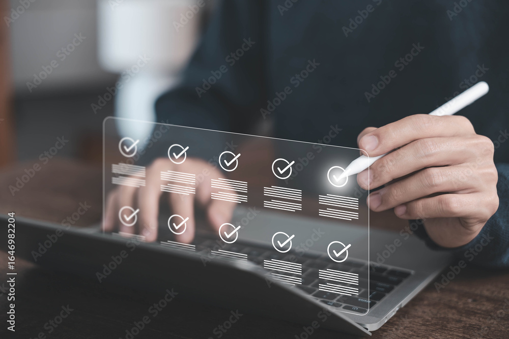 Aufkleber businessman using digital checklist interface on laptop for task management and productivity trackin