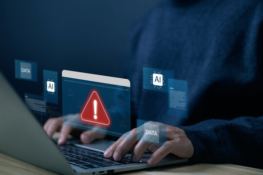 Businessman using laptop with cybersecurity alert warning on screen, protecting AI data, preventing cyber threats in artificial intelligence systems and digital environments. warning AI systems error