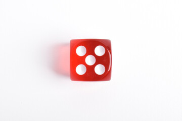 One red dice isolated on white background, top view