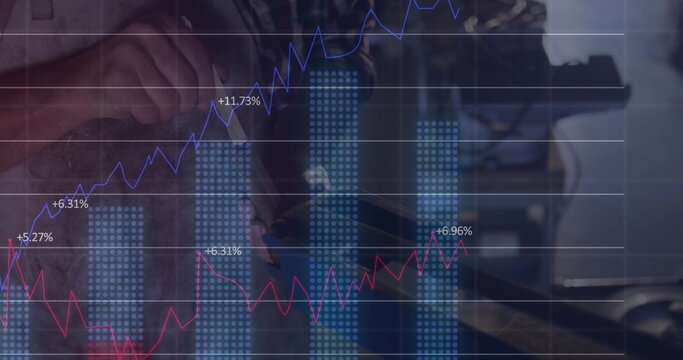 Male technician measuring engine component in workshop, with digital caliper and chart overlays