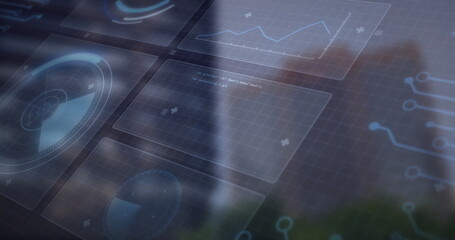 Projecting holographic interface showing radar dial, line graph and circuit traces in city office