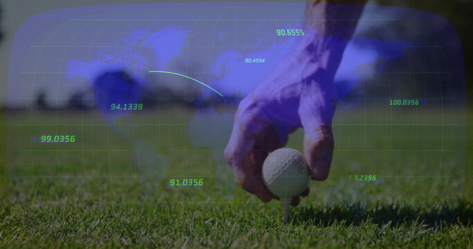 Golfer hand positioning golf ball on tee on trimmed grass, showing world map overlay, copy space