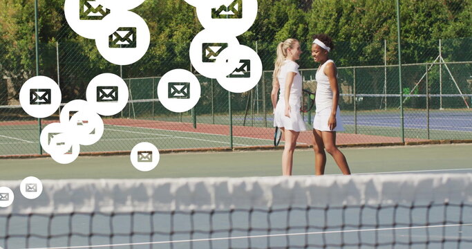 Practicing tennis players holding rackets on hard court, with floating mail notification icons - Powered by Adobe