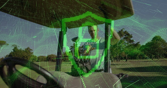 Standing adult male golfer holding smartphone on golf cart on fairway, with digital shield overlay - Powered by Adobe