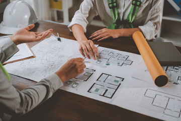 Architects reviewing house plans in a meeting
