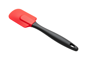 Red silicone spatula kitchen utensil for mixing cooking and baking on white