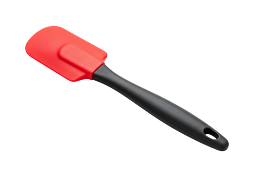 Red silicone spatula kitchen utensil for mixing cooking and baking on white