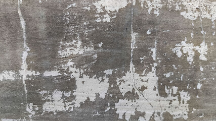 Distressed horizontal surface of concrete wall showing scratches, cracks, and worn cement for use in grunge backgrounds, architectural design, or texture archives.