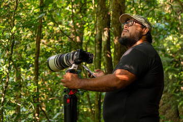 Fototapeta premium Wildlife photographer exploring in search of animals in the rainforest