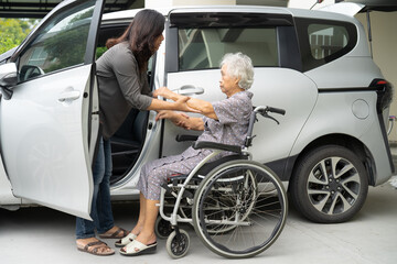 Caregiver help and support asian elderly woman sitting on wheelchair prepare get to her car to...