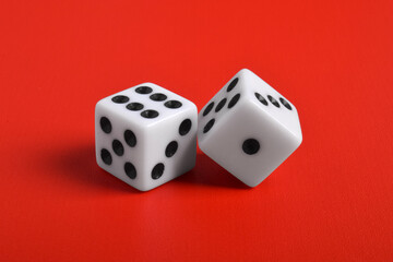 Two white dice isolated on red background