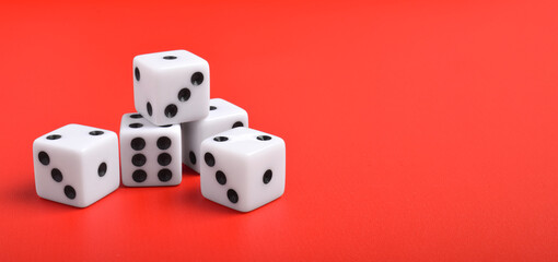 Many dices isolated on red background with copy space for text