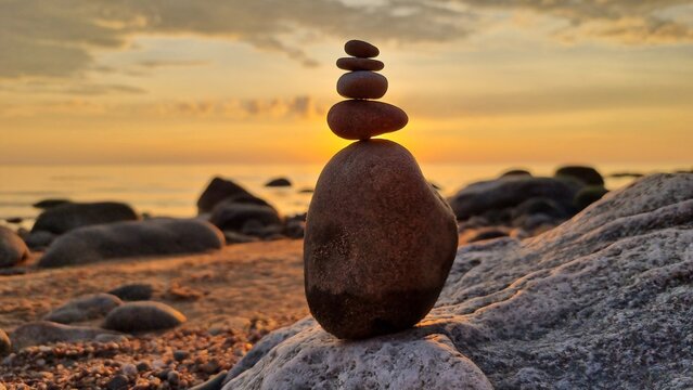 Zen balance at sunset on a Baltic sea rocky shore, Veczemju Klintis, Latvia