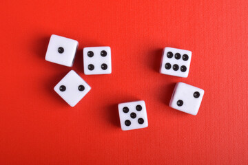 Dices isolated on red background, top view