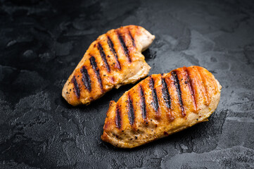 Grilled chicken breasts, eco farm poultry meat, top view, black background.