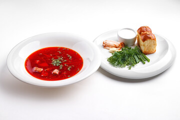 A creative gourmet dish with a piece of meat, a red sauce, and a side of vegetable tartare topped with a delicate flower petal on a white plate.